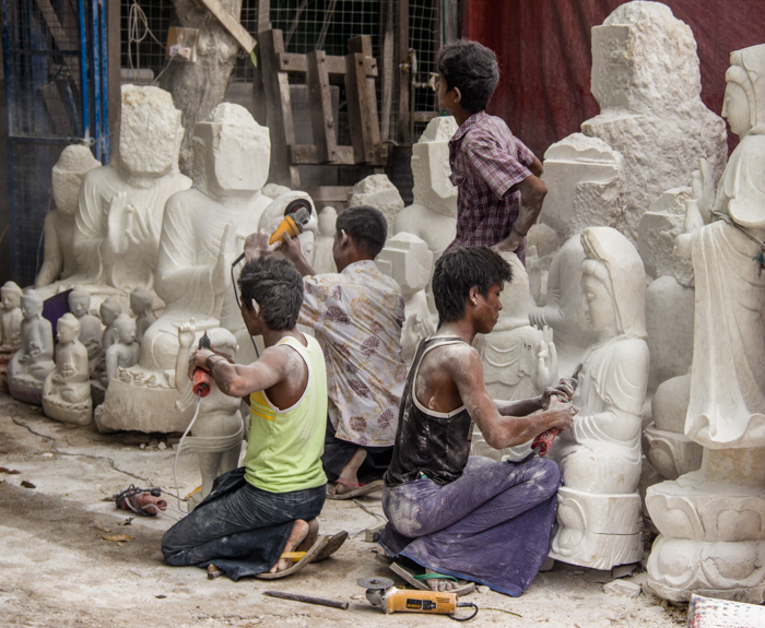 Young workers carving away. Tradition with the help of modern tools.