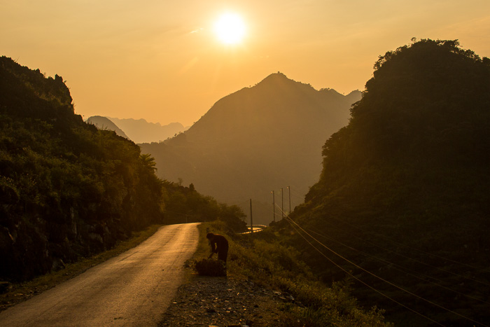 Sunset over Ha Giang Province and a lone Hmong woman