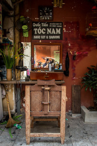 Reflections at the outdoor barber shop Hanoi